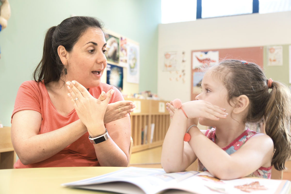 Sign language teacher with child signing